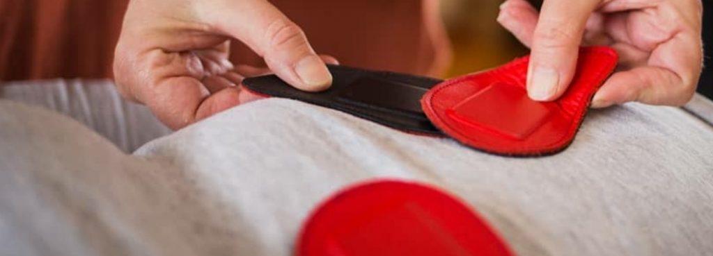 biomagnetic pair therapy session person placing magnets onto another person