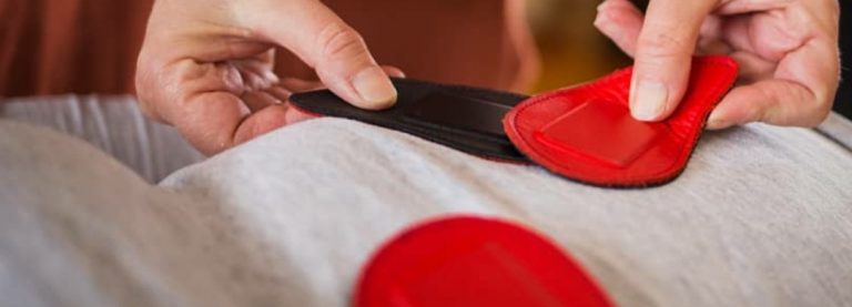 biomagnetic pair therapy session person placing magnets onto another person
