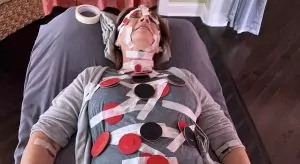 image of a woman lying down with magnets taped on her