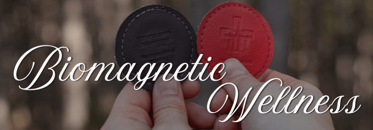 biomagnetic wellness text over an image of magnets held by hands in the forrest